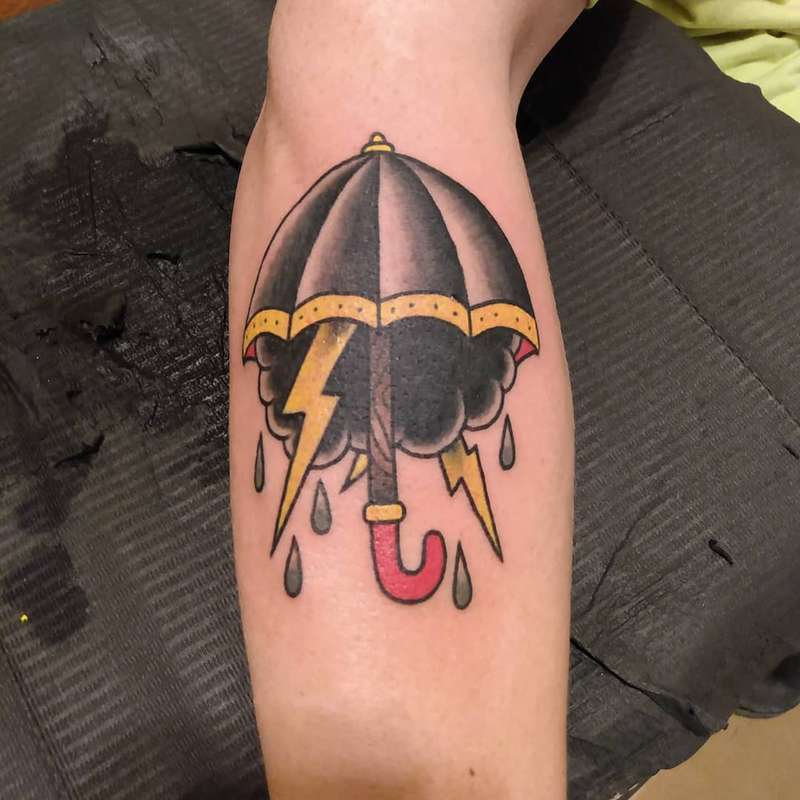 umbrella with lightning tattoo on calf