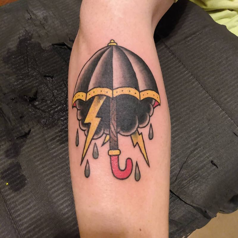 umbrella with lightning tattoo on calf