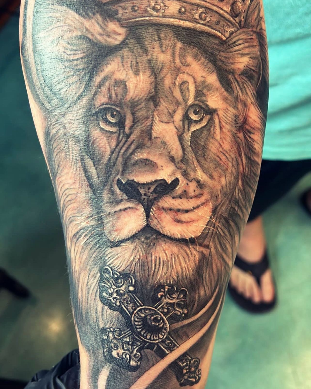 Black and grey realistic lion tattoo on forearm