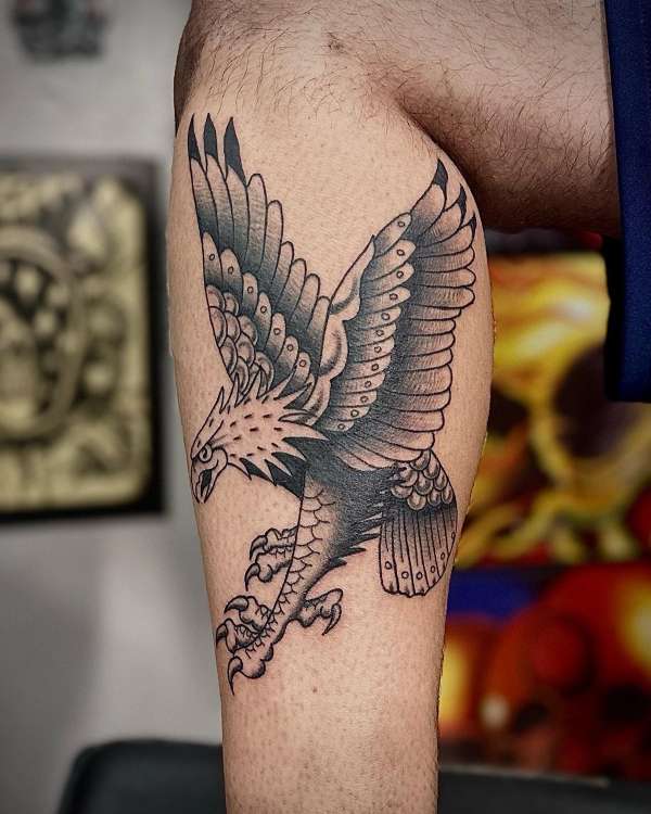 black ink eagle tattoo on thigh