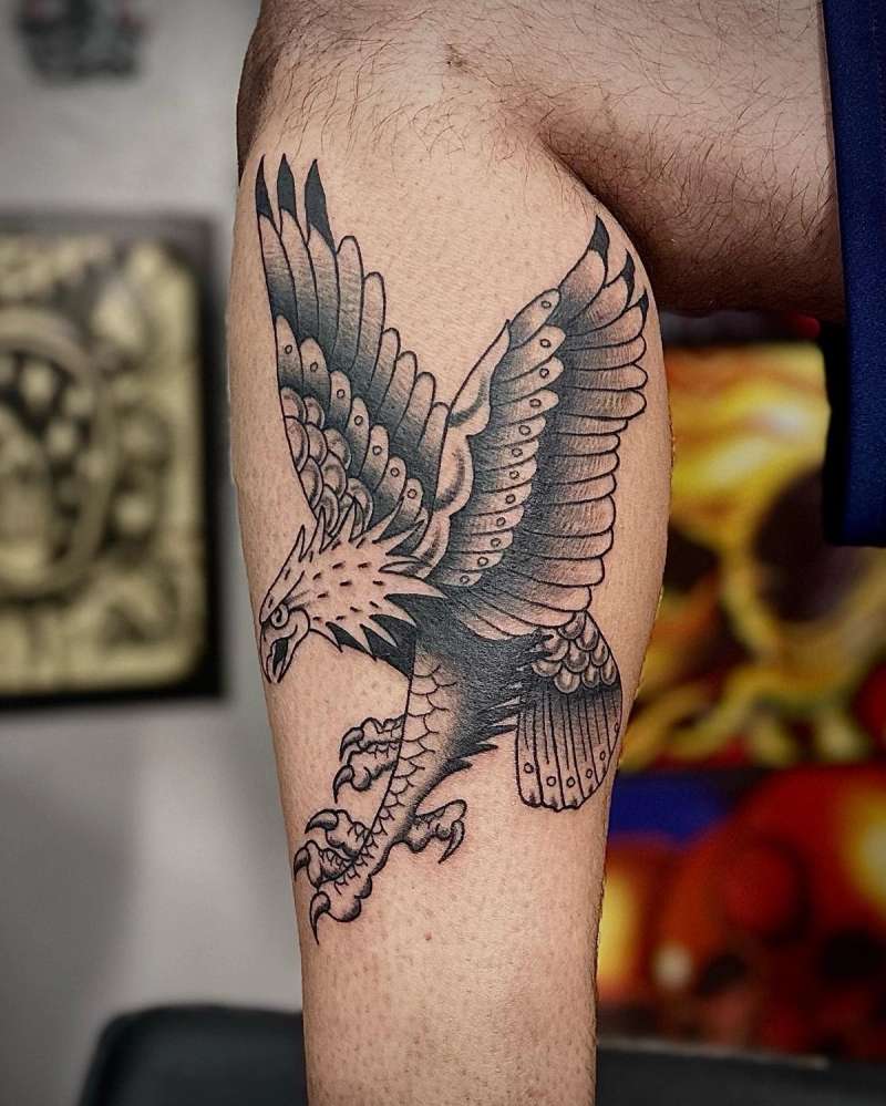 black ink eagle tattoo on thigh