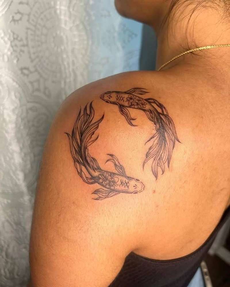 Black and grey koi fish illustrative tattoo on shoulder
