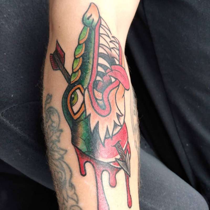 colorful wolf tattoo on forearm