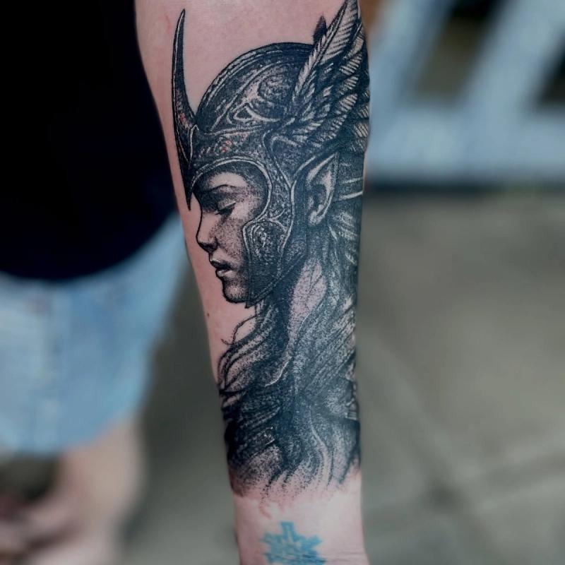 black and grey valkyrie forearm tattoo with winged helmet
