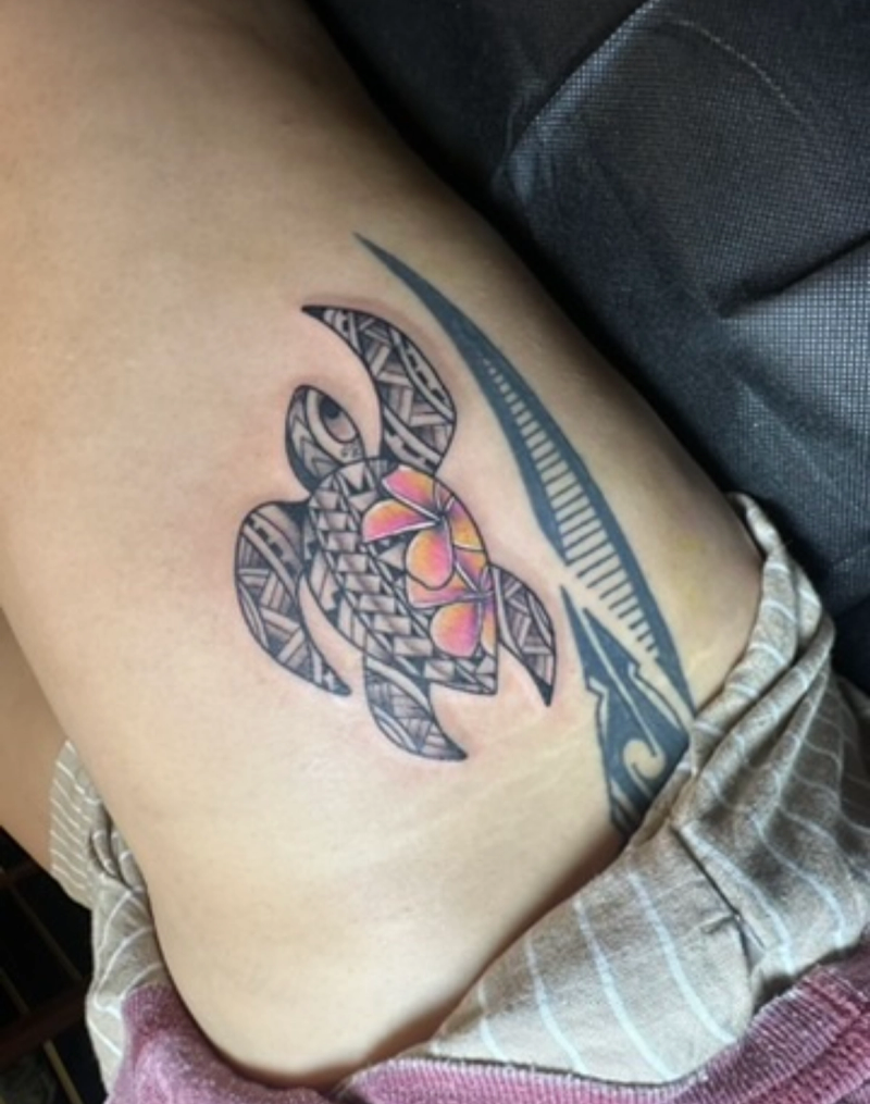 Colorful tribal turtle tattoo on upper thigh