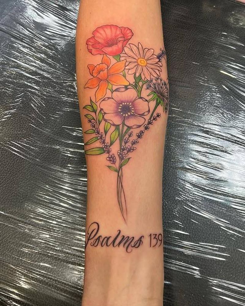 colorful floral tattoo with script on forearm