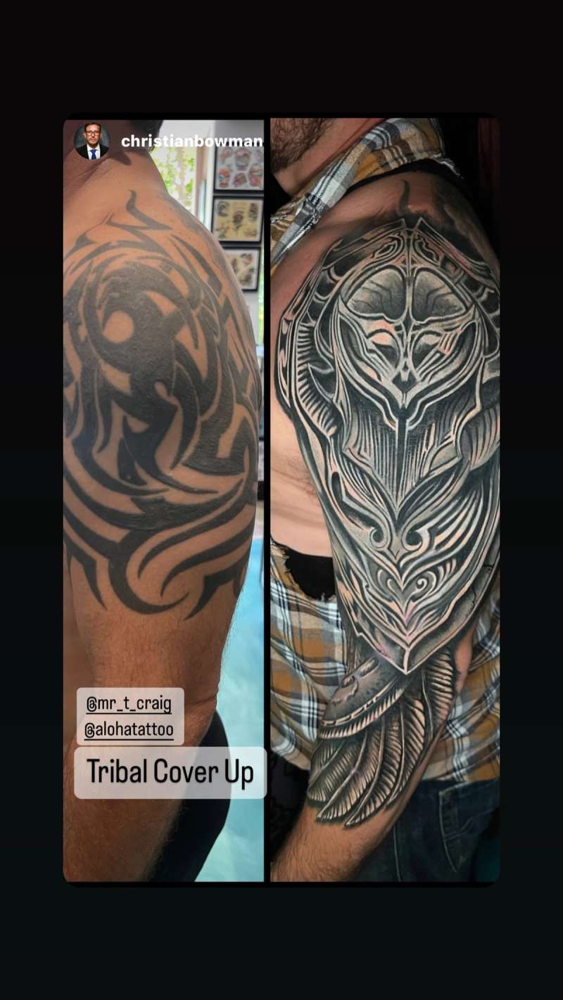 Black and grey tribal design covering upper arm