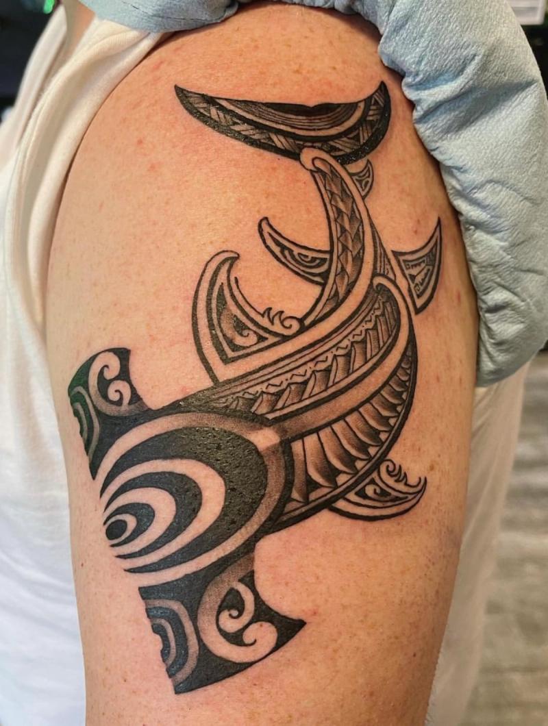 Black tribal hammerhead shark tattoo on upper arm