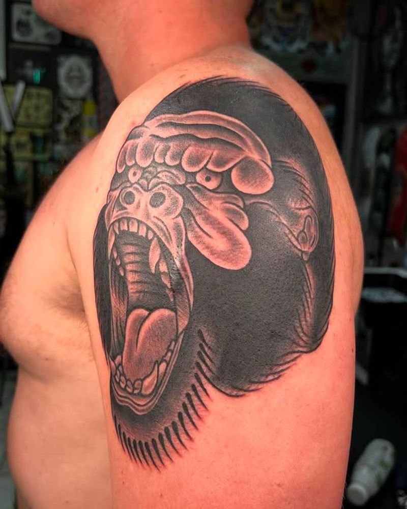 Blackwork illustrative ape tattoo on upper arm