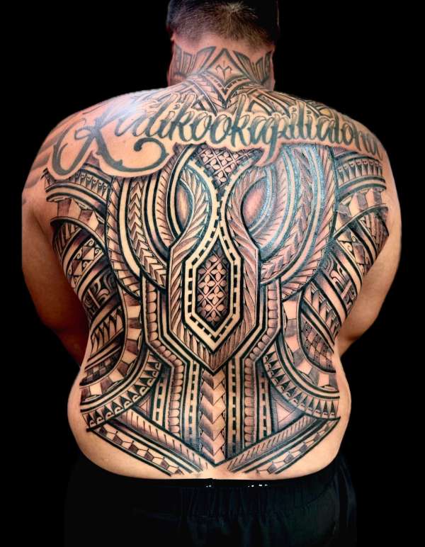 Blackwork tribal tattoo with script covering full back