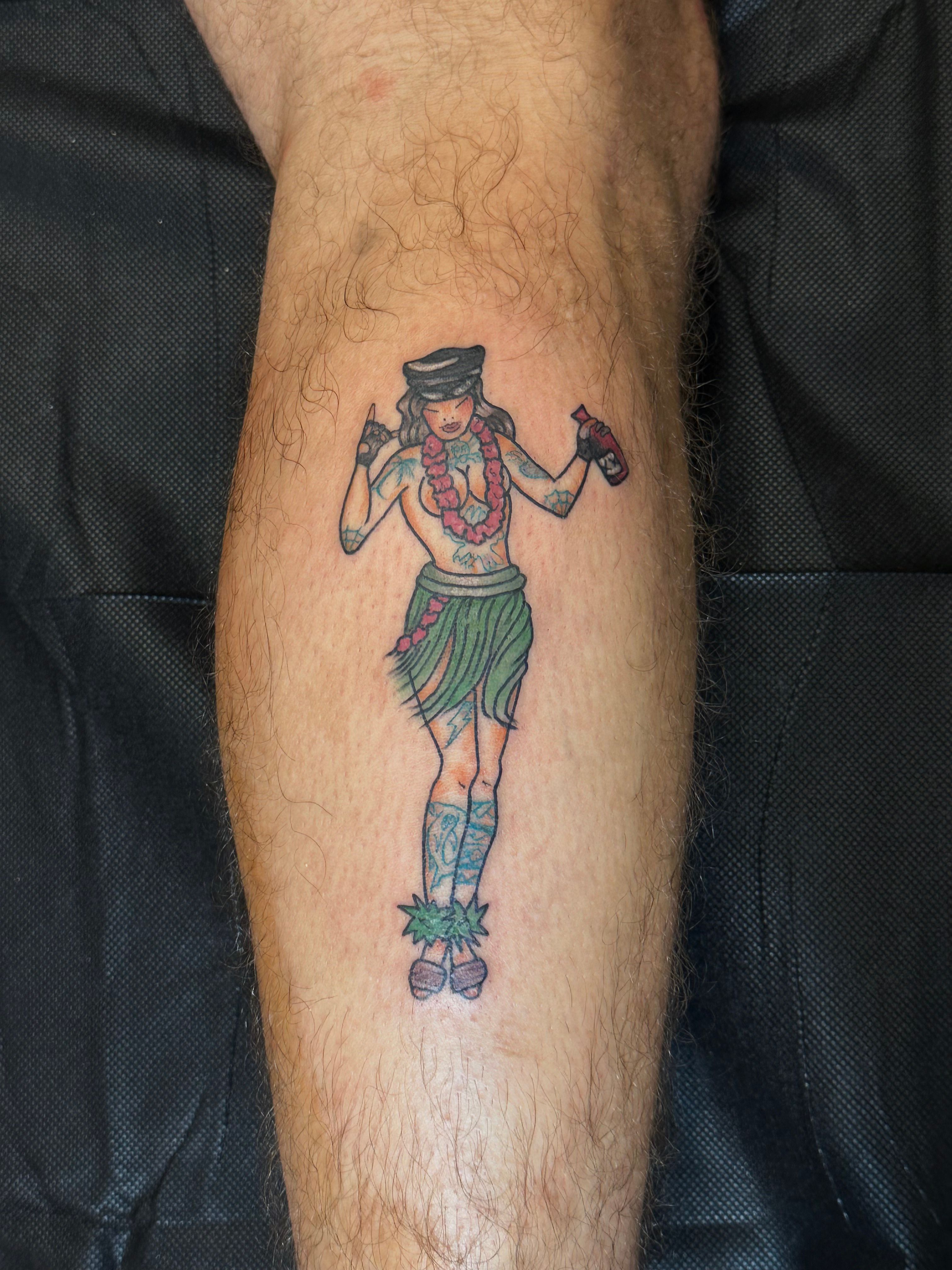 Colorful illustrative hula dancer tattoo on calf.