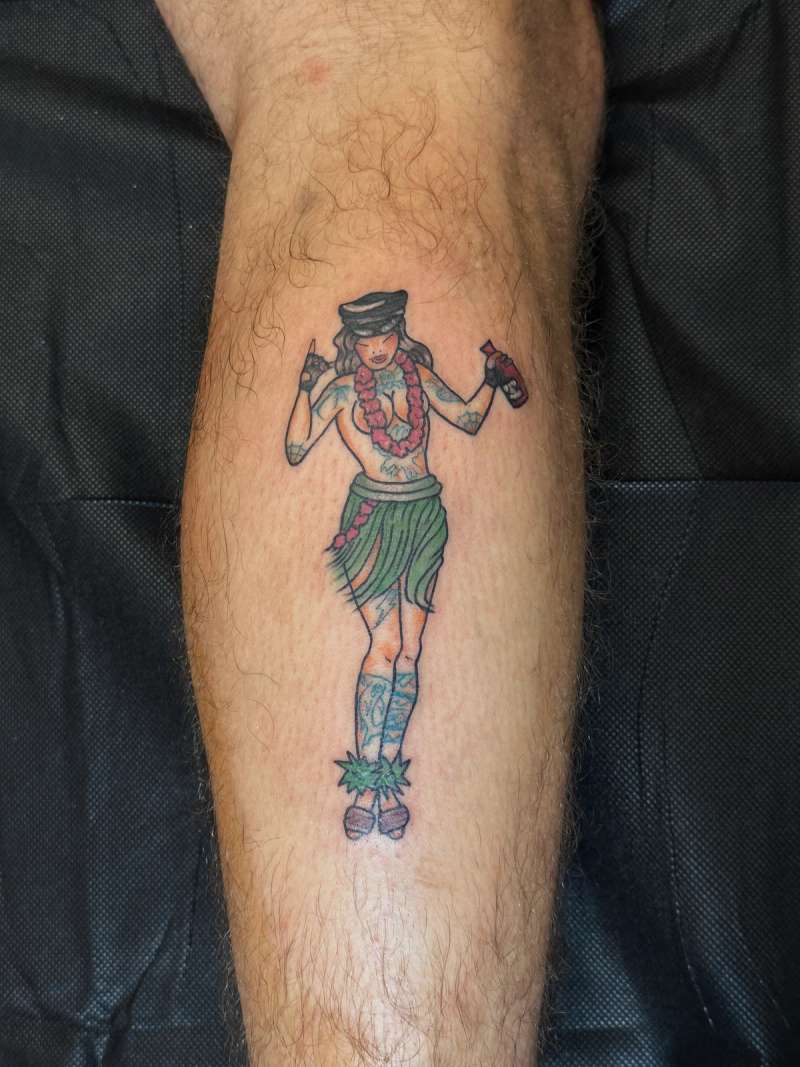 Colorful illustrative hula dancer tattoo on calf.