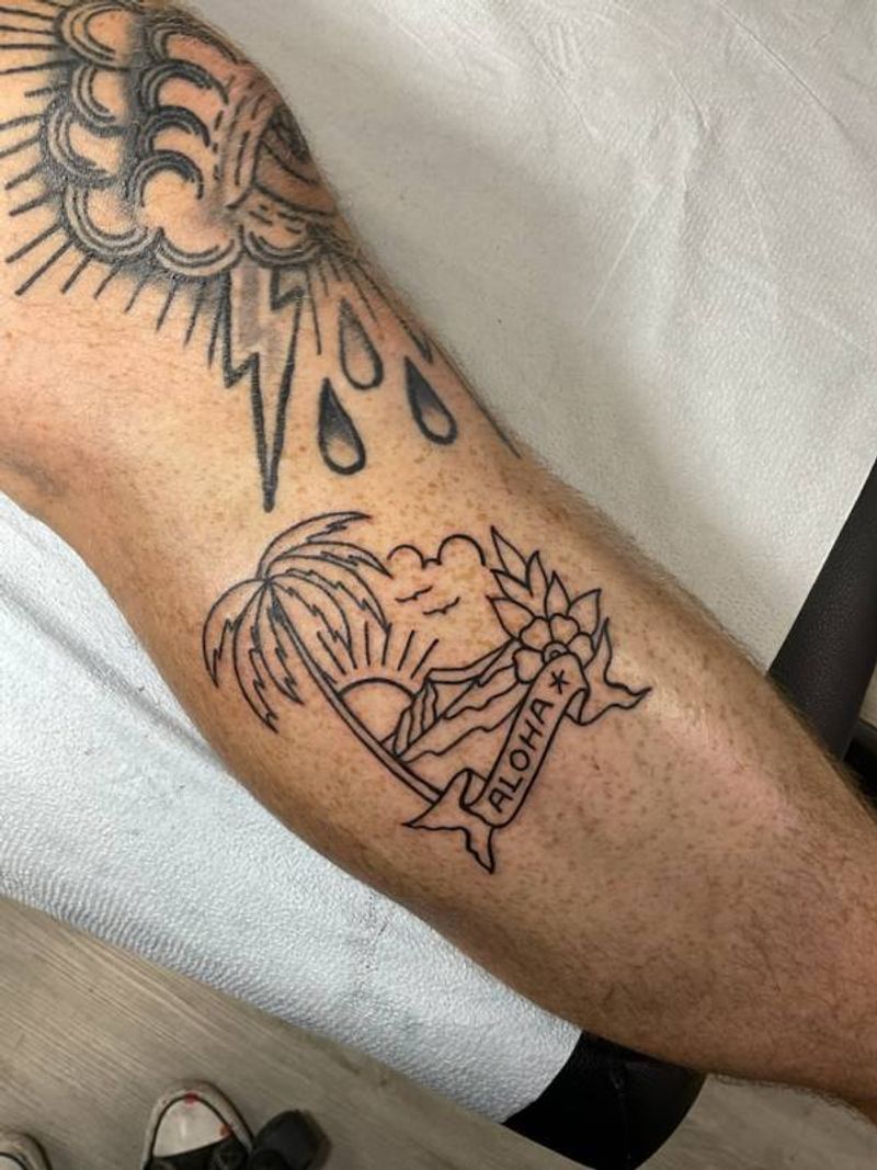 blackwork tattoo with aloha and sunset theme on a leg