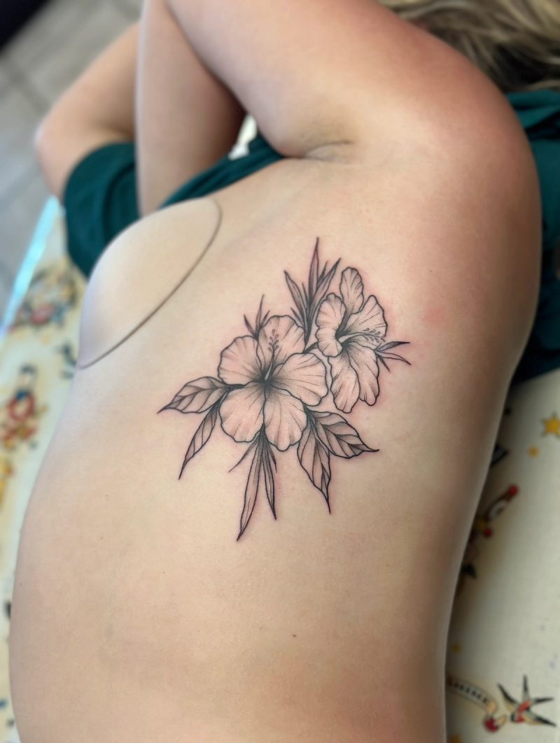 Black and grey fine line hibiscus flowers tattoo on torso