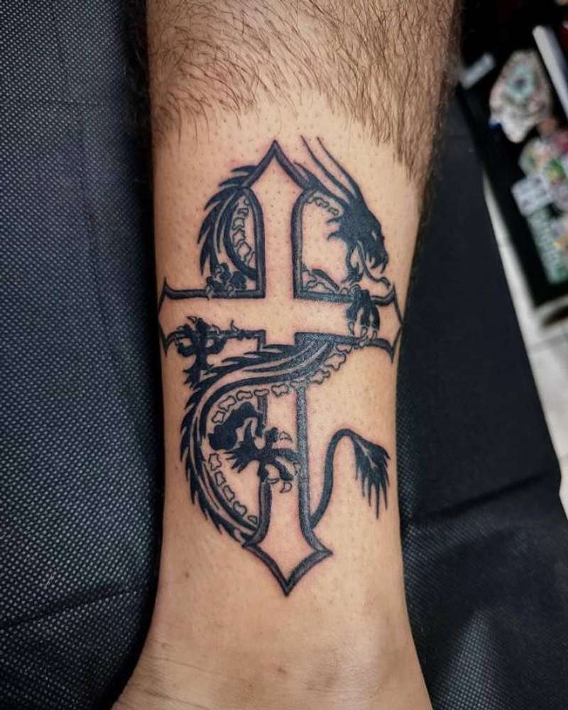 blackwork dragon and cross tattoo on calf