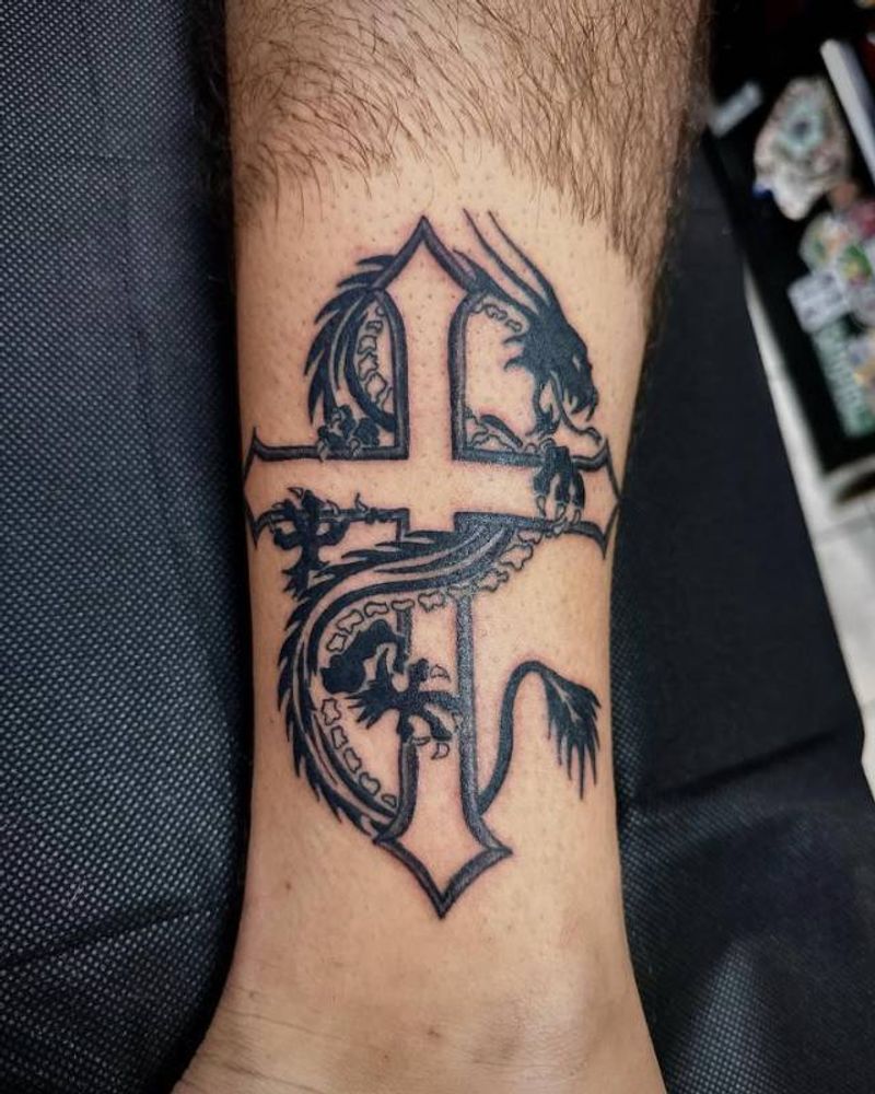 blackwork dragon and cross tattoo on calf