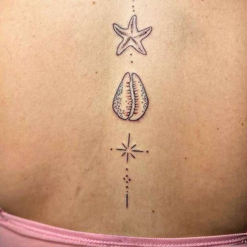 Minimalist black and grey starfish and shell tattoo on upper back