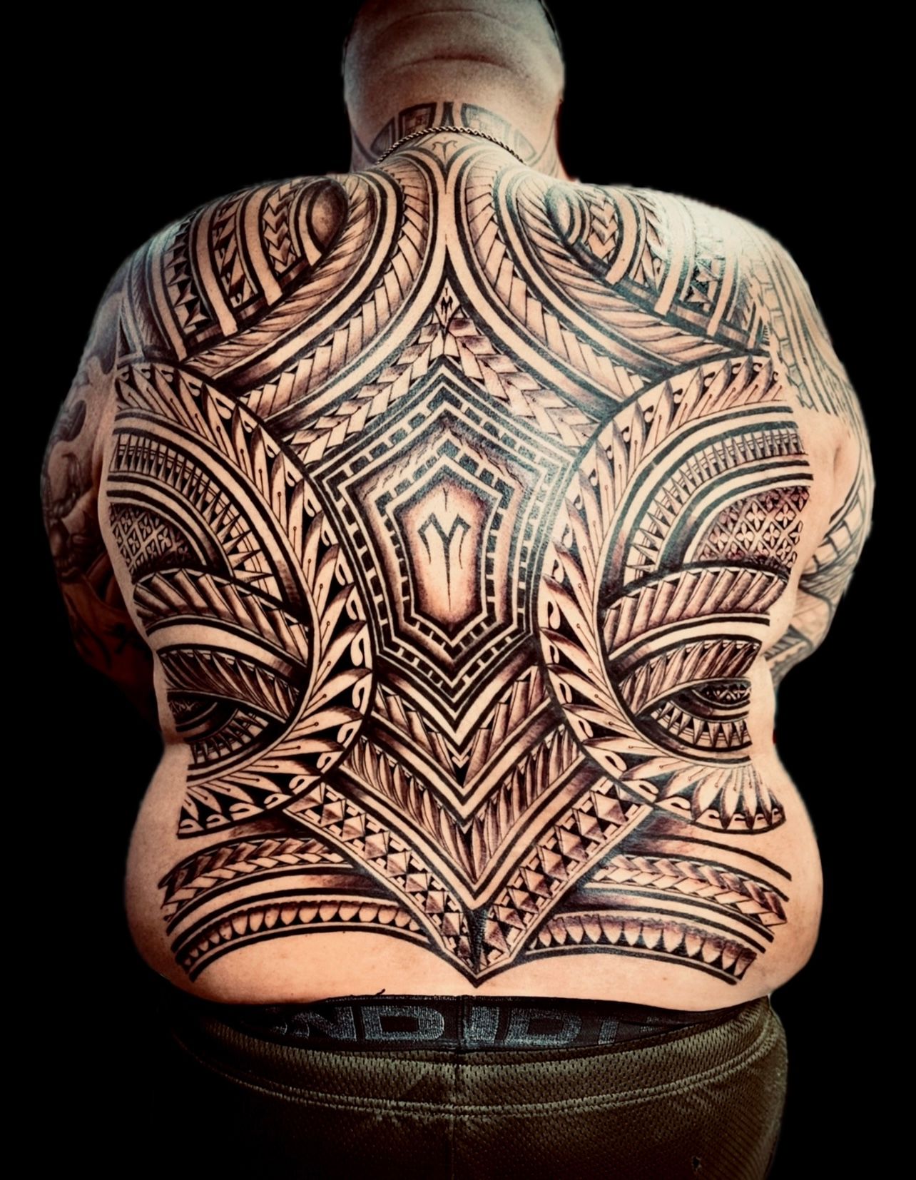 Tribal blackwork tattoo covering entire back