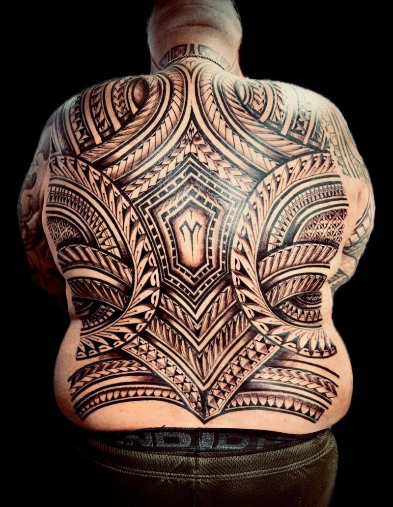 Tribal blackwork tattoo covering entire back