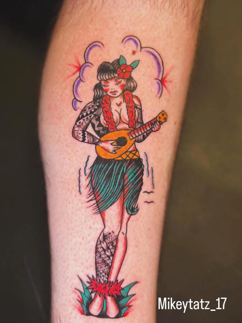 traditional american style hula girl playing ukulele on forearm