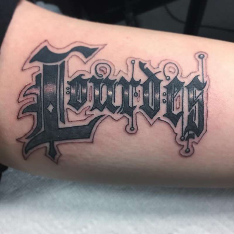 lettering tattoo on forearm