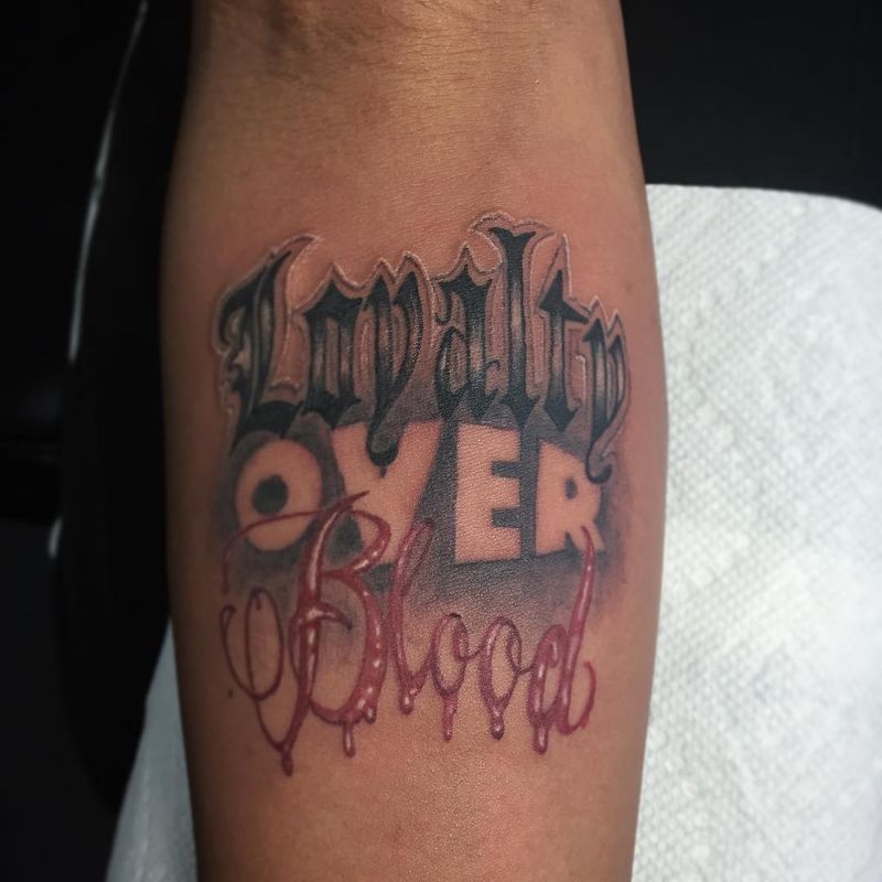 colorful lettering tattoo on forearm