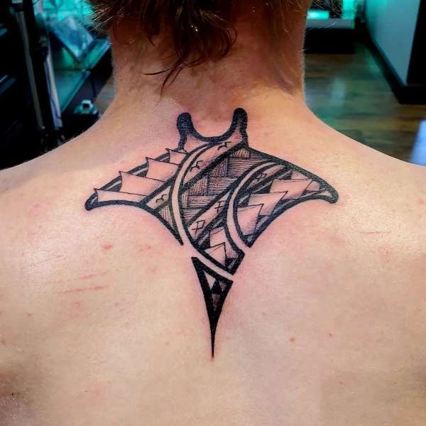 Blackwork tribal manta ray tattoo on upper back