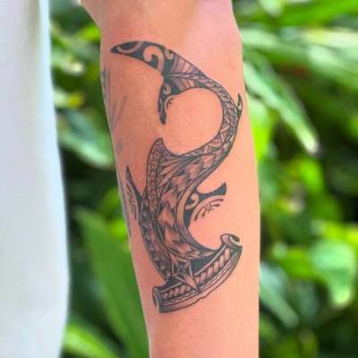 Tribal blackwork shark tattoo on forearm