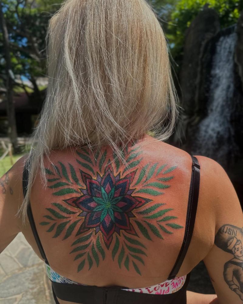colorful geometric and botanical upper back tattoo