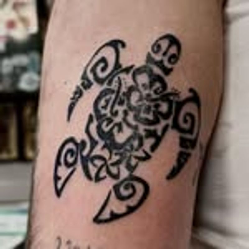 tribal turtle tattoo on upper arm