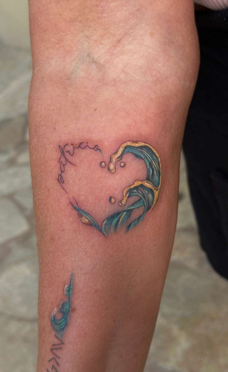 Colorful heart-shaped wave tattoo on forearm