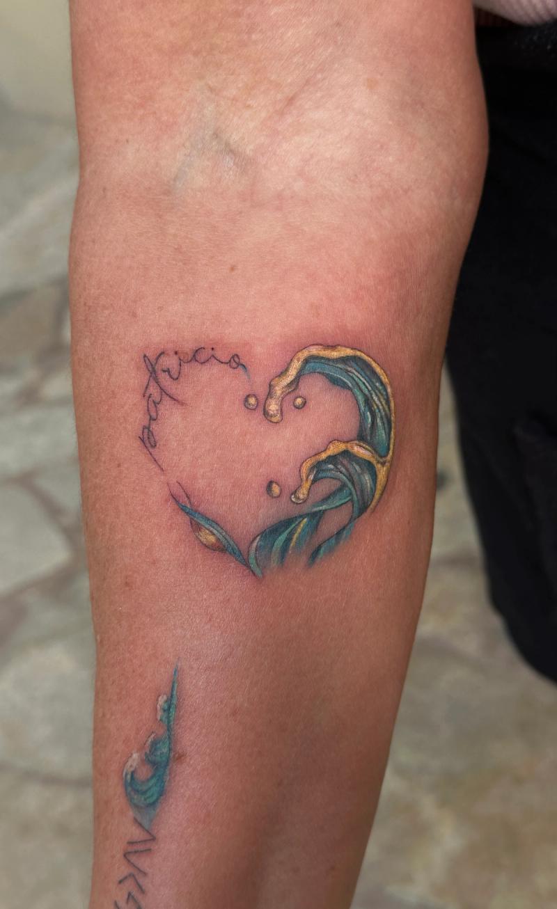 Colorful heart-shaped wave tattoo on forearm