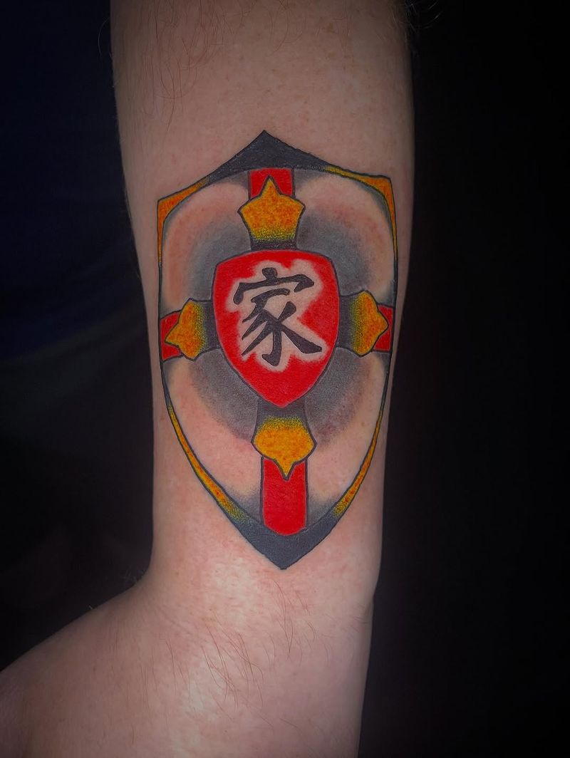 Colorful geometric shield tattoo on forearm