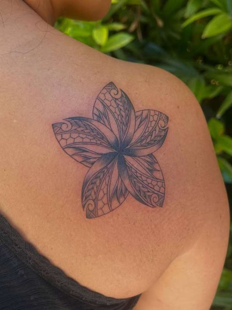 Black and grey geometric floral tattoo on shoulder