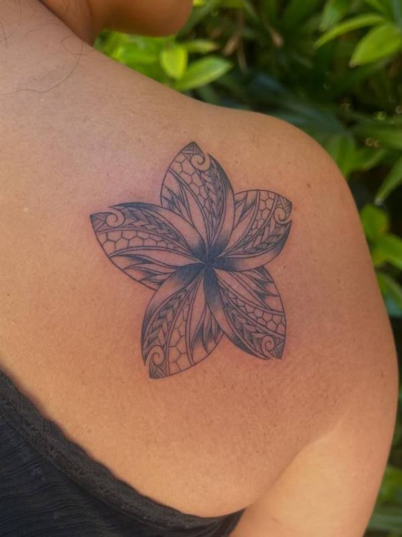 Black and grey geometric floral tattoo on shoulder