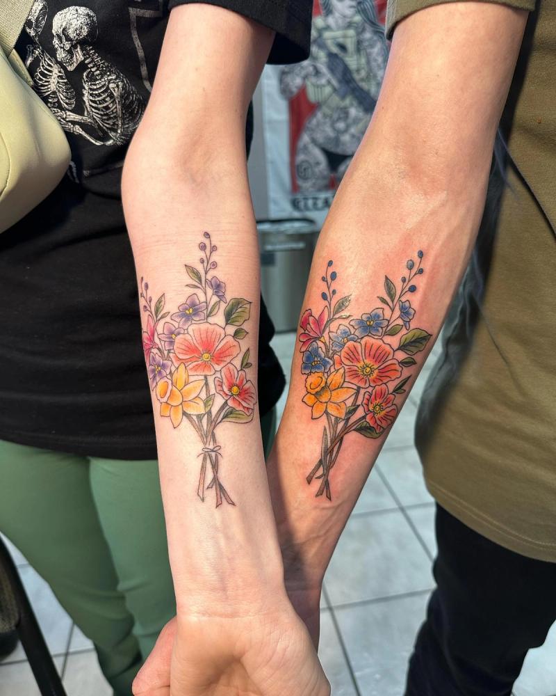 colorful floral tattoos on forearms