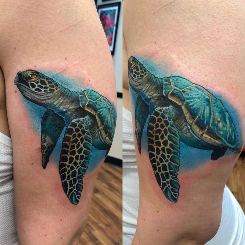 realistic sea turtle tattoo on upper arm