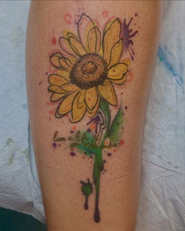 colorful sunflower and text tattoo on calf