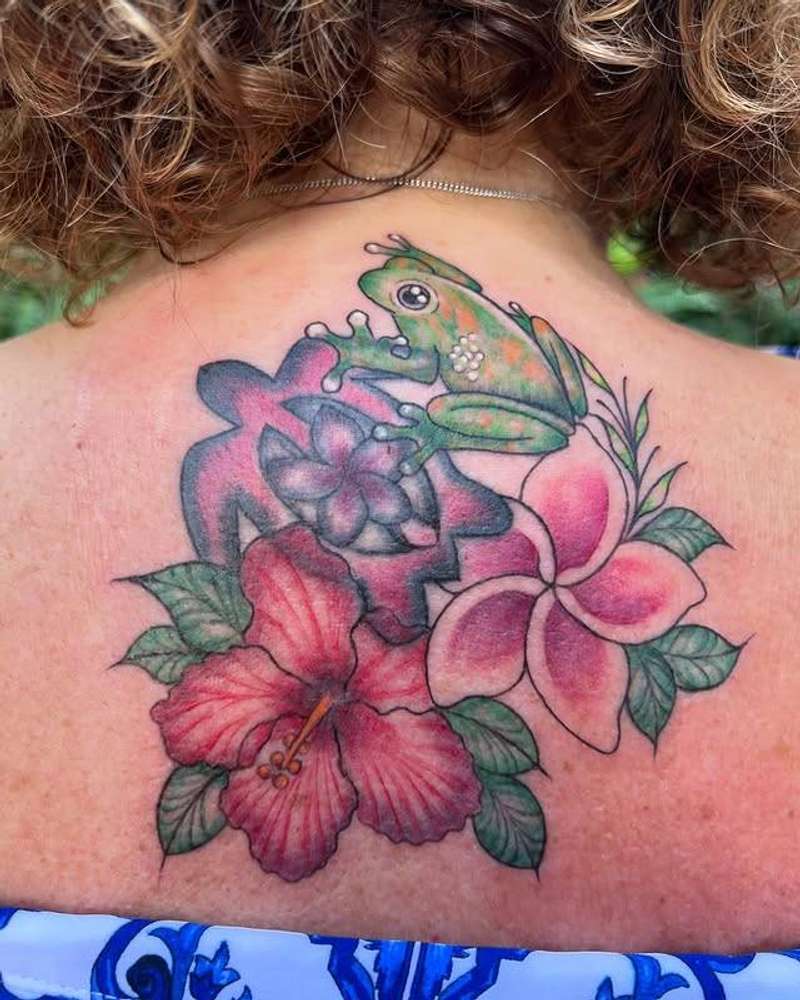 tattoo of a colorful frog and flowers on upper back