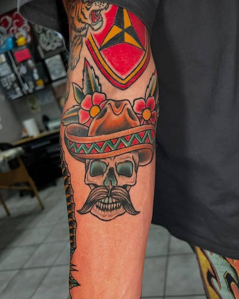 Colorful traditional skull with sombrero on forearm