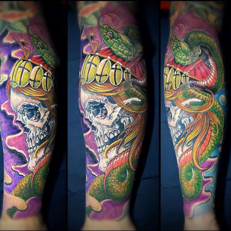 Colorful Neo Traditional snake and skull tattoo on forearm