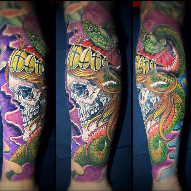 Colorful Neo Traditional snake and skull tattoo on forearm