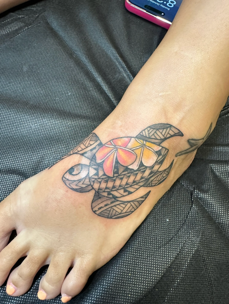 Colorful geometric turtle tattoo on foot