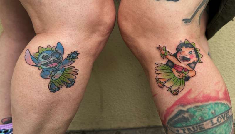 Colorful cartoon character tattoos on calves