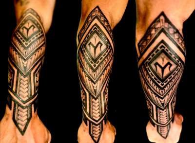 Black geometric tribal pattern tattoo on forearm