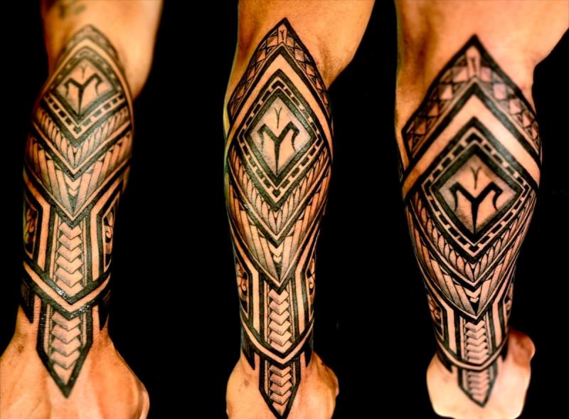 Black geometric tribal pattern tattoo on forearm