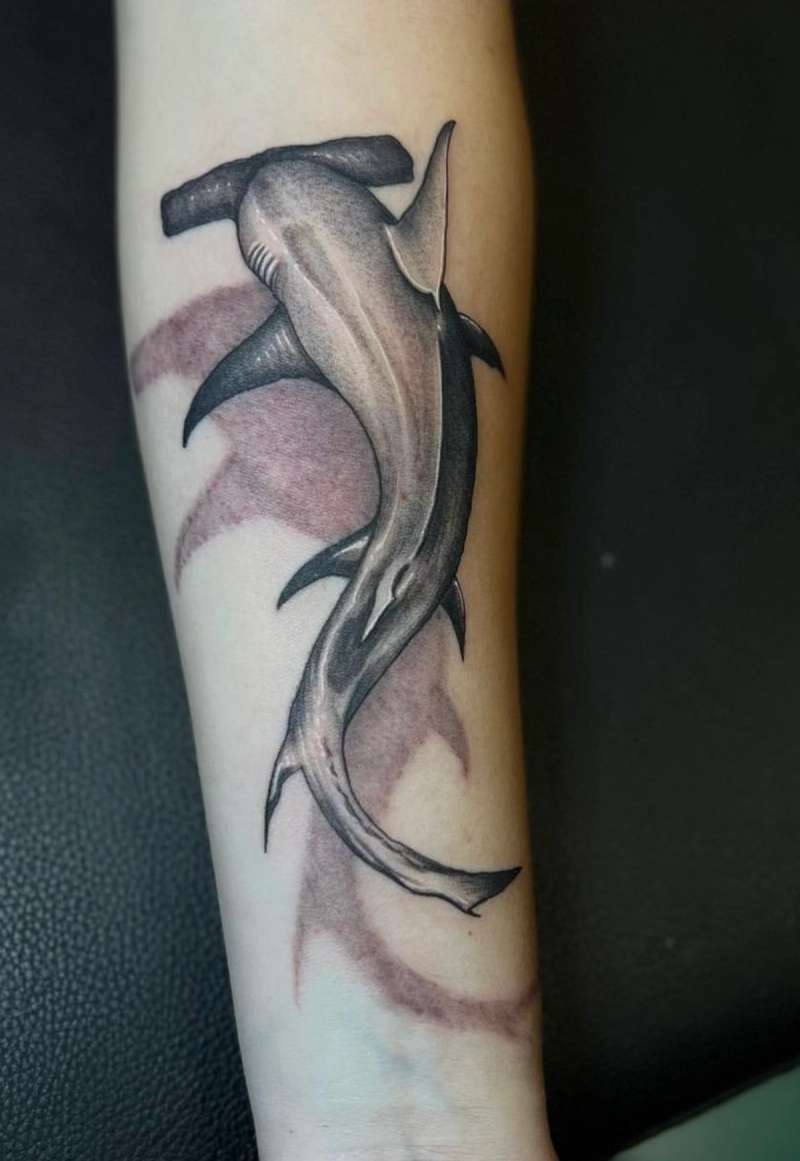 Black and grey realistic hammerhead shark tattoo on forearm