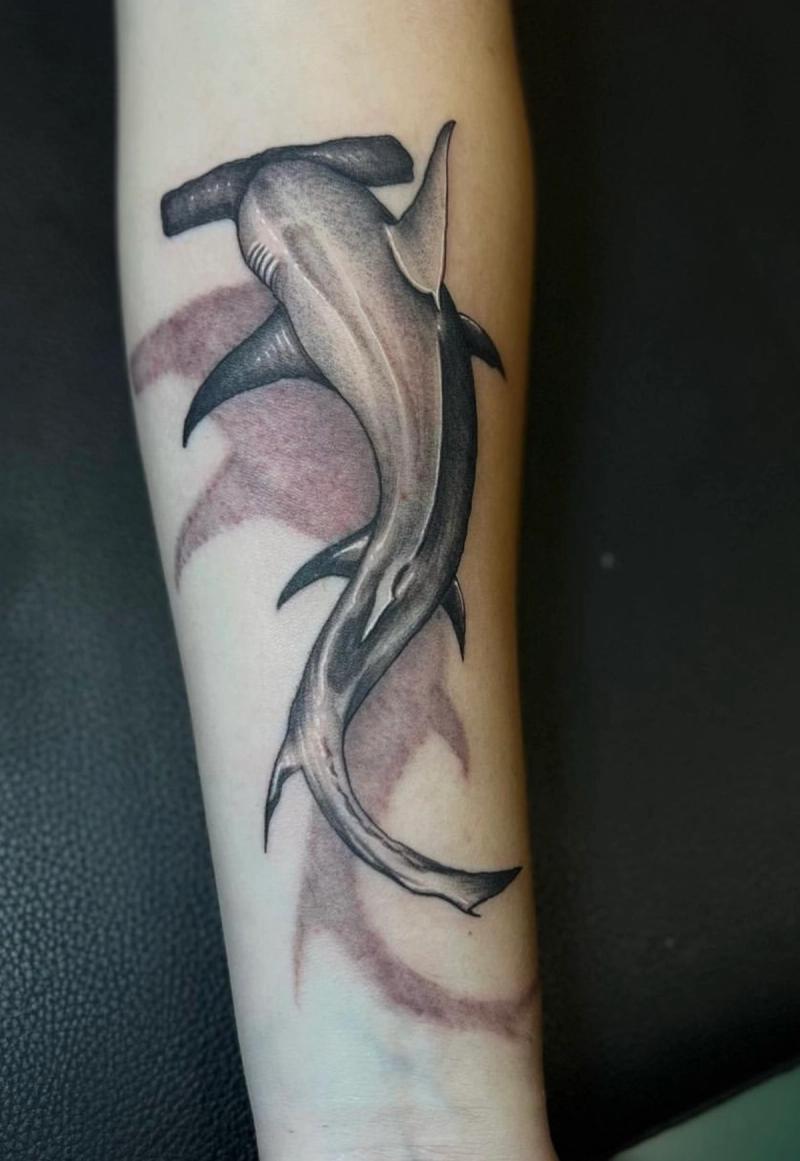 Black and grey realistic hammerhead shark tattoo on forearm