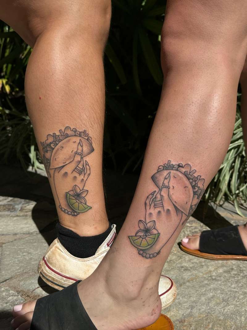 Colorful taco and hand tattoo on calf