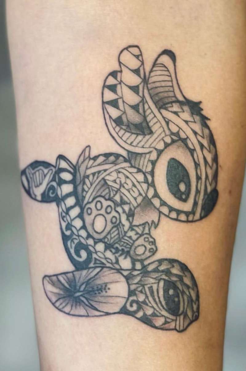 Geometric blackwork tattoo of an abstract animal on forearm